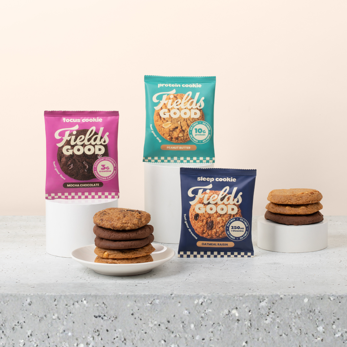 Focus, Protein and Sleep Cookie packs on pedestals with stacks of each cookie