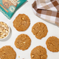 Fields Good Peanut butter cookies with a bowl of peanuts and a package on a white surface.