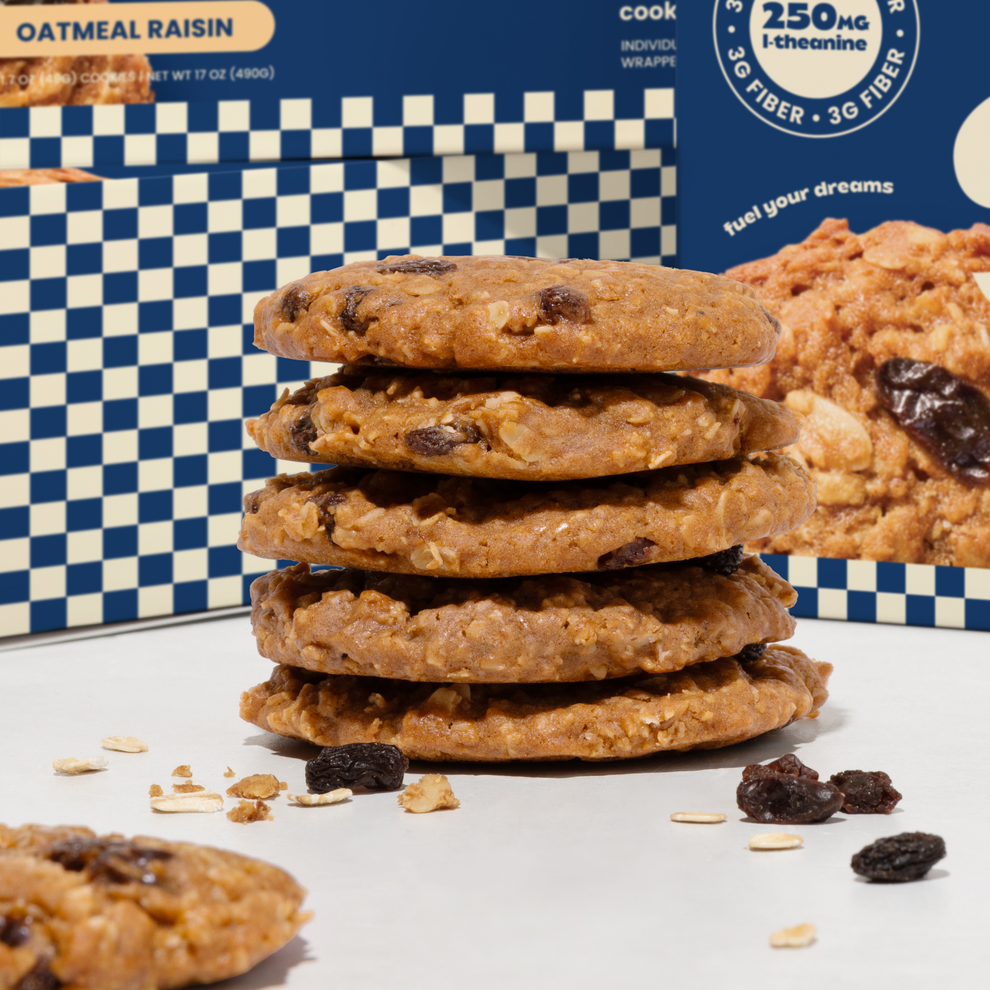 Stack of oatmeal raisin cookies with a blue and white checkered box in the background