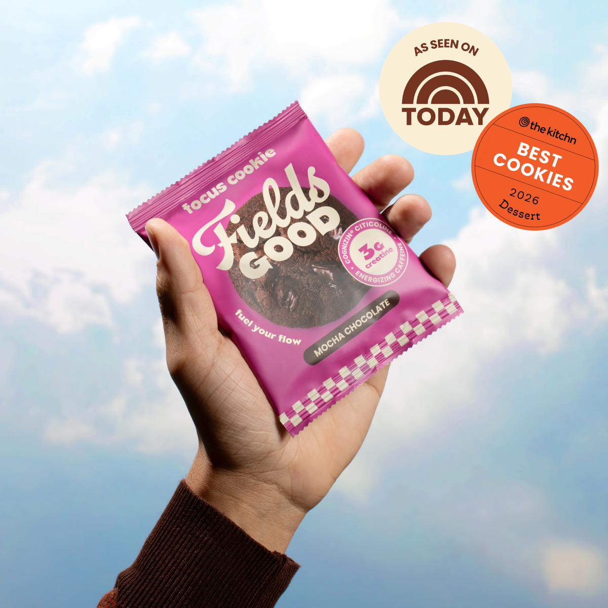 Hand holding a Fields Good Focus cookie package against a blue sky background, with an 'As Seen On TODAY' badge.