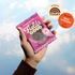 Hand holding a Fields Good Focus cookie package against a blue sky background, with an &